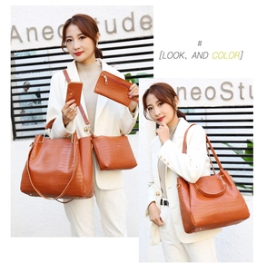 Detail view of 4-piece crocodile pattern bag set with tote, crossbody and gold ring handles