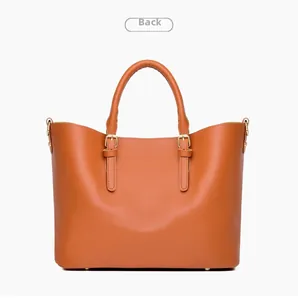 Detailed back view of a large brown leather tote bag with stitching and metal D-rings