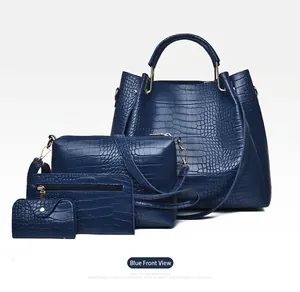 Macro shot of 4-piece dark blue crocodile embossed leather tote and purse set