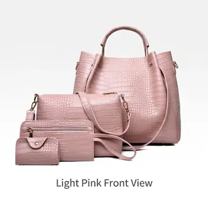Detail of four-piece light pink handbag set featuring crocodile texture and gold metal handles