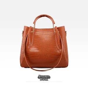 Detailed back view of a brown tote bag featuring textured faux crocodile skin and gold hardware