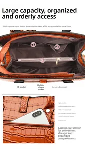 Detail view of the brown embossed crocodile leather tote with interior zipper pockets
