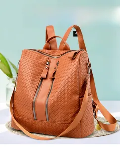 Detail view of the brown woven texture PU leather backpack with side pockets and zippers