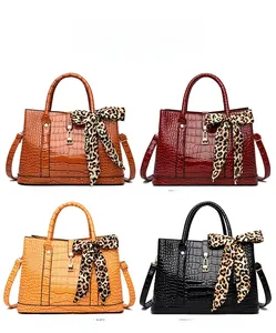 Detailed color display of embossed crocodile texture handbags in four classic shades