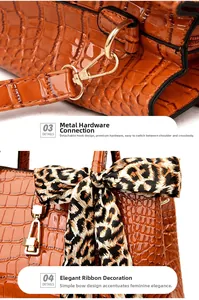 Detail of orange crocodile pattern bag with gold hardware and leopard ribbon bow