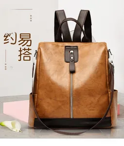Brown vintage multi-functional faux leather backpack with vertical metal zipper detailing