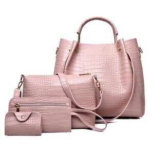 Pink 4-piece embossed faux leather handbag set with tote, crossbody bag, and wallets