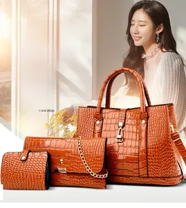 Three-piece women bag set in brown crocodile pattern leather with gold metal accents