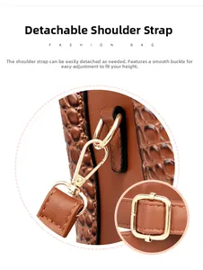 Detail view of brown crocodile texture bag with gold metal buckle and adjustable strap