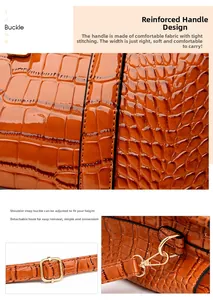 Detail of orange crocodile pattern tote with reinforced handles and golden metal buckle