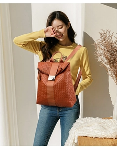 Gros plan du sac à dos tissé marron avec boucle en métal argenté sur sangle en cuir