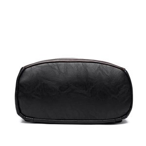 Bottom view of black PU leather backpack showing high-quality lychee texture and stitching