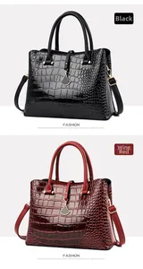 Detail of crocodile embossed leather texture on black and wine red fashion handbags