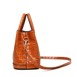Brown crocodile pattern tote bag with double handles and adjustable gold strap