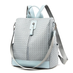 Light blue woven multi-way backpack with top handle and crossbody straps for travel