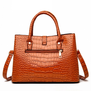 Three-piece crocodile pattern handbag set in orange with adjustable strap and gold hardware