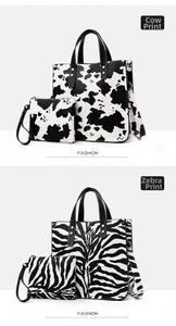 Detail view of large capacity tote bag set with cow and zebra patterns and metal buckles