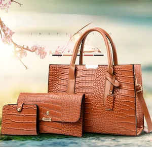 Detailed view of 3-piece brown crocodile pattern PU tote set with gold-tone hardware
