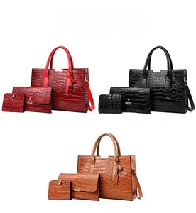 Three-piece women bag set showing crocodile embossed tote, envelope clutch and wallet