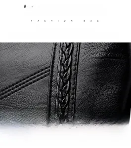 Detailed macro view of black litchi grain leather texture and woven stitching craftsmanship