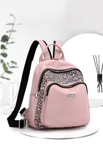 Pink Oxford cloth backpack detail showing versatile straps and geometric texture