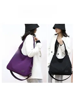 Dual view of large nylon hobo bags in purple and black with adjustable shoulder straps