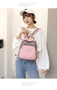 Pink Oxford fabric backpack featuring geometric patterns and durable metal zippers