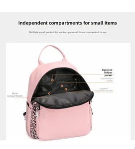 Detailed interior of the pink Oxford backpack showing zipper pockets and compartments