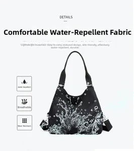 Waterproof black nylon tote bag with splash pattern showing durable detachable strap