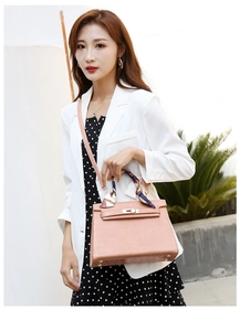 Pink embossed handbag with stone pattern featuring silk scarf and golden buckle detail