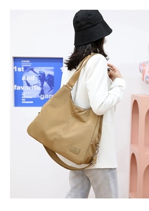 Khaki nylon tote bag displayed on model showing large capacity and soft texture