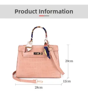 Pink croc-embossed handbag with ribbon handle and dimensions 28x20x12cm