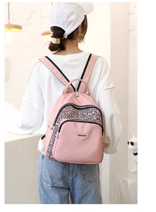 Rear view of a woman wearing a pink Oxford backpack with modern geometric lines