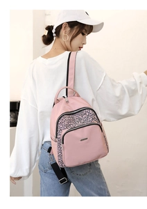 Close-up of pink Oxford cloth backpack with geometric pattern shown on model