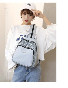 Detailed close-up of light blue Oxford backpack with black and white geometric pattern