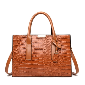 Brown crocodile embossed tote bag with gold hardware and a detachable shoulder strap