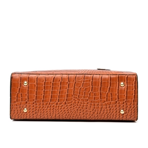 Brown faux crocodile leather handbag bottom with four protective golden metal feet