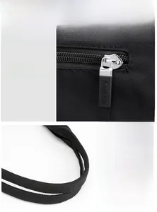 Detail of durable nylon fabric with smooth metal zipper and reinforced woven handle