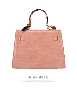 Pink embossed crocodile texture handbag featuring a silk scarf wrapped handle detail