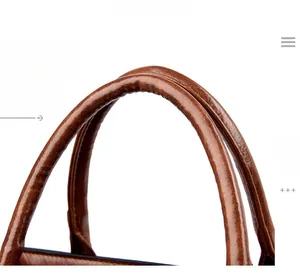 Detail of brown cowhide leather handles with precise stitching and refined edge painting