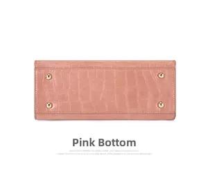 Pink croc-embossed bag bottom with four protective gold metal feet for wear resistance