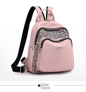 Detailed side view of pink oxford backpack with black geometric lines and silver zippers