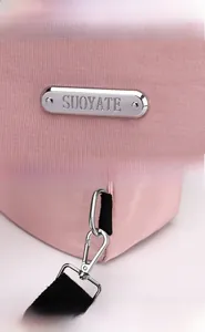 Detailed macro of pink nylon fabric with silver metal logo and removable snap hook