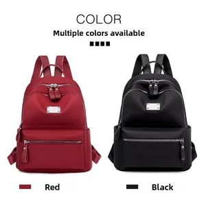 Front view of stylish red and black nylon backpacks with decorative metal plates