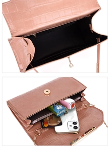 Detail view of pink crocodile embossed handbag showing interior capacity and magnetic closure