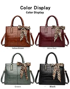 Detailed grid of four glossy crocodile-pattern handbags in yellow-brown, red, green, and black