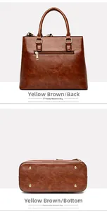 Detail of tan crocodile texture bag showing back zip pocket and bottom studs with scarf