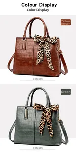 Detail of crocodile pattern leather handbag with leopard print scarf and metal strap