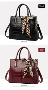 Detail of crocodile pattern handbags in black and wine red with leopard silk scarves