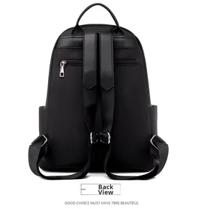 Detail view of the back of black oxford fabric backpack with hidden anti-theft zipper pocket